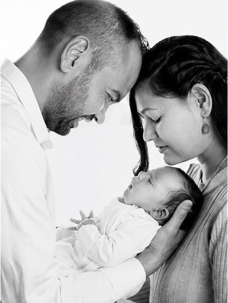 Parents holding their newborn at a Lazuro studio photoshoot